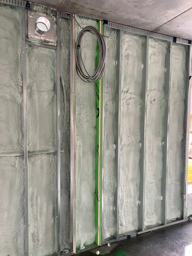 Foamed wall with mineral wool at a column and wiring in place