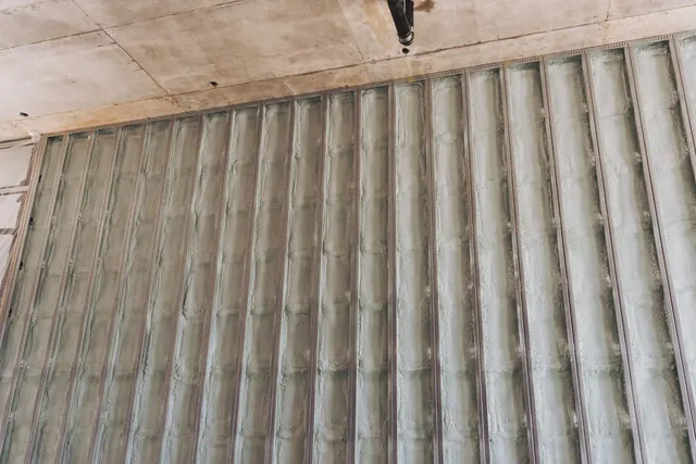 A long exterior wall with closed-cell foam filling every stud cavity to the sheathing