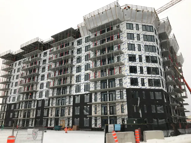 A nine-story building with sheathing on every floor and cladding started at the base