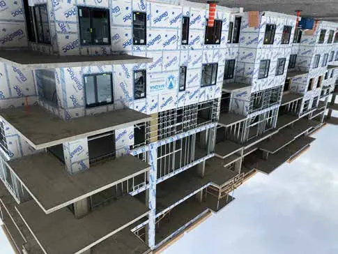 Ilot St. Charles Project: a multi-story building with taped sheathing and balconies