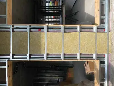 Mineral wool at a slab edge between Z-bars