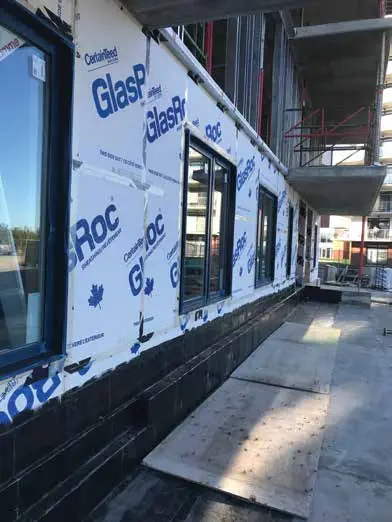 Taped exterior sheathing panels on a building face